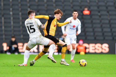 140226 - Milton Keynes Dons v Newport County - Sky Bet League 2 - Michael Spellman of Newport County is tackled by Luke Offord of MK Dons 