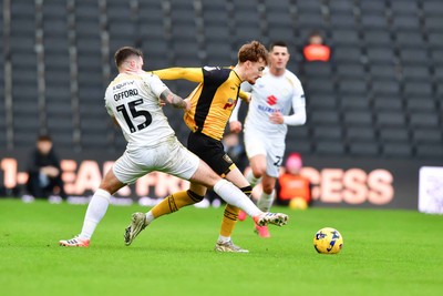 140226 - Milton Keynes Dons v Newport County - Sky Bet League 2 - Michael Spellman of Newport County is tackled by Luke Offord of MK Dons 