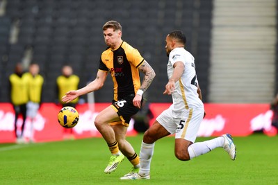 140226 - Milton Keynes Dons v Newport County - Sky Bet League 2 - James Crole of Newport County and Curtis Nelson of MK Dons 