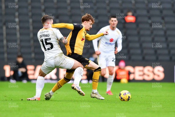 140226 - Milton Keynes Dons v Newport County - Sky Bet League 2 - Michael Spellman of Newport County is tackled by Luke Offord of MK Dons 