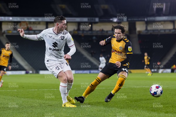 221122 - Milton Keynes Dons v Newport County - Papa Johns Trophy -  Louie Barry of Milton Keynes Dons is challenged by Aaron Lewis of Newport County