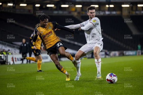 221122 - Milton Keynes Dons v Newport County - Papa Johns Trophy -  Nathan Moriah-Welsh of Newport County is challenged by Daniel Harvie of Milton Keynes Dons