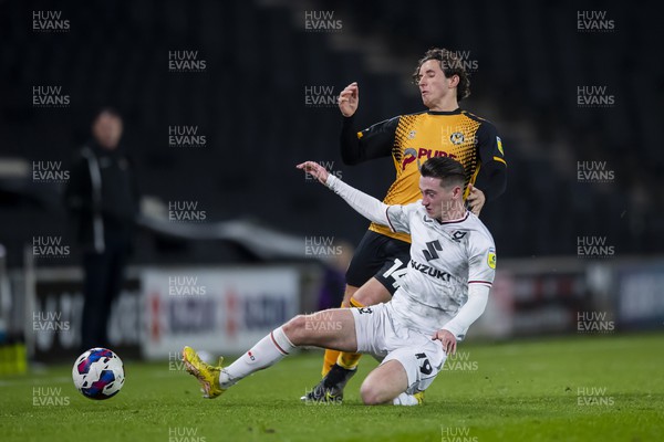 221122 - Milton Keynes Dons v Newport County - Papa Johns Trophy -  Aaron Lewis of Newport County is tackled by Louie Barry of Milton Keynes Dons