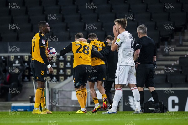 221122 - Milton Keynes Dons v Newport County - Papa Johns Trophy -  Adam Lewis of Newport County limps off the pitch held by Mickey Demetriou of Newport County