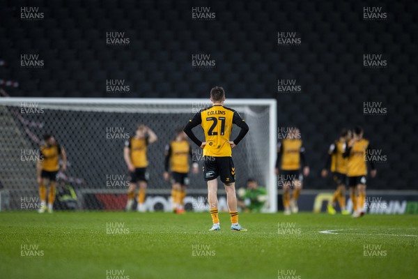 221122 - Milton Keynes Dons v Newport County - Papa Johns Trophy -  Newport County players dejected after MK Dons score their second goal