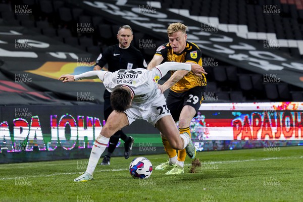 221122 - Milton Keynes Dons v Newport County - Papa Johns Trophy -  Daniel Harvie of Milton Keynes Dons is challenged by Will Evans of Newport County