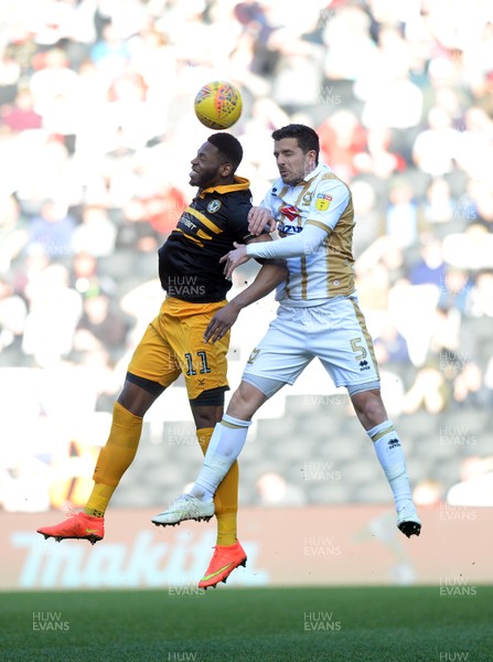 230219 MK Dons v Newport County - Sky Bet League 2 -   Mathieu Baudry of MK Dons goes for a header with Newports Jamille Matt