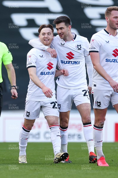 240224 - MK Dons v Newport County, EFL Sky Bet League 2 - Dan Kemp of MK Dons, left, celebrates with team mates after scoring the opening goal