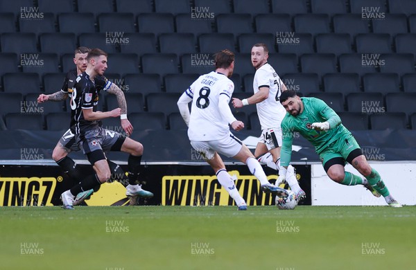 240224 - MK Dons v Newport County, EFL Sky Bet League 2 - Alex Gilbey of MK Dons beats Newport County goalkeeper Nick Townsend to score the third goal
