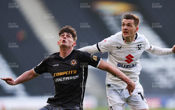 240224 - MK Dons v Newport County, EFL Sky Bet League 2 - Seb Palmer-Houlden of Newport County and Joe Tomlinson of MK Dons compete for the ball