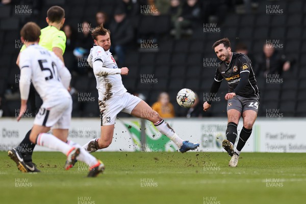 240224 - MK Dons v Newport County, EFL Sky Bet League 2 - Aaron Wildig of Newport County plays the ball as Alex Gilbey of MK Dons closes in