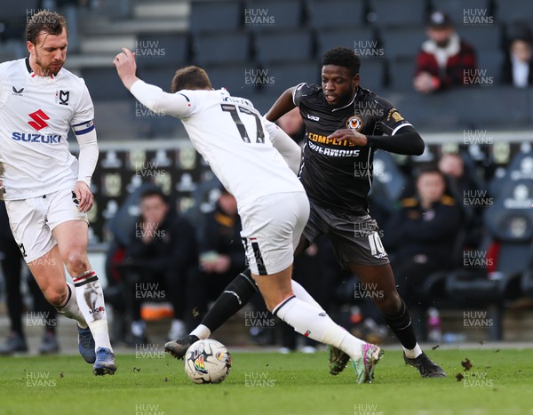240224 - MK Dons v Newport County, EFL Sky Bet League 2 - Offrande Zanzala of Newport County  and Ethan Robson of MK Dons compete for the ball