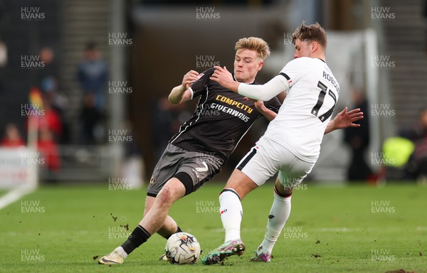 240224 - MK Dons v Newport County, EFL Sky Bet League 2 - Will Evans of Newport County takes on Ethan Robson of MK Dons