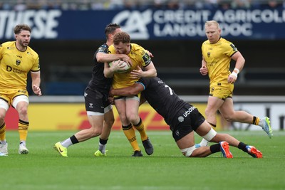 030526 - Montpellier Herault Rugby v Dragons RFC - EPCR Challenge Cup Semi Final - Aneurin Owen of Dragons is tackled by Thomas Vincent and Alex Becognee of Montpellier 