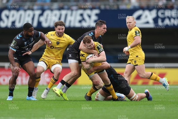 030526 - Montpellier Herault Rugby v Dragons RFC - EPCR Challenge Cup Semi Final - Aneurin Owen of Dragons is tackled by Thomas Vincent of Montpellier 