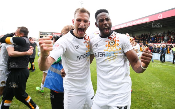 040519 - Morecambe v Newport County, Sky Bet League 2 - Mickey Demetriou of Newport County and Jamille Matt of Newport County celebrate on hearing the news that Newport County had made the Division 2 Play Offs