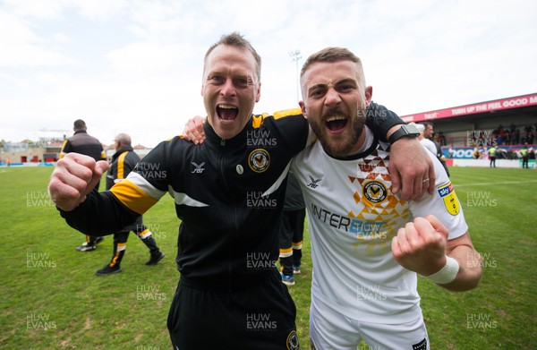 040519 - Morecambe v Newport County, Sky Bet League 2 - Newport County manager Michael Flynn and Dan Butler of Newport County celebrate on hearing the news that they had made the Division 2 Play Offs