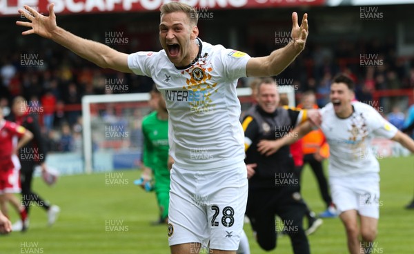 040519 - Morecambe v Newport County, Sky Bet League 2 - Mickey Demetriou of Newport County celebrates with team mates on hearing the news that Newport County had made the Play Offs