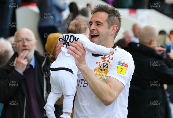040519 - Morecambe v Newport County, Sky Bet League 2 - Matty Dolan of Newport County celebrates with his child on hearing the news that Newport County had made the Play Offs