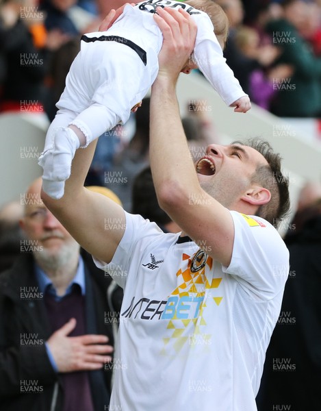 040519 - Morecambe v Newport County, Sky Bet League 2 - Matty Dolan of Newport County celebrates with his child on hearing the news that Newport County had made the Play Offs