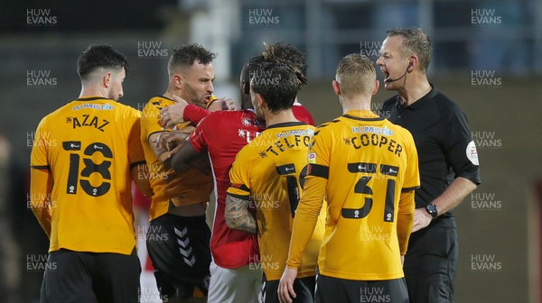 061121 - Morecambe v Newport County - FA Cup First Round - Robbie Willmott of Newport County is cautioned as Morecambe player is on ground and Greg Leigh of Morecambe FC grabs him with referee Chris Sarginson shouting at them both