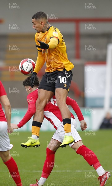 061121 - Morecambe v Newport County - FA Cup First Round - Courtney Baker-Richardson of Newport County rises up to head the ball over Callum Jones of Morecambe FC