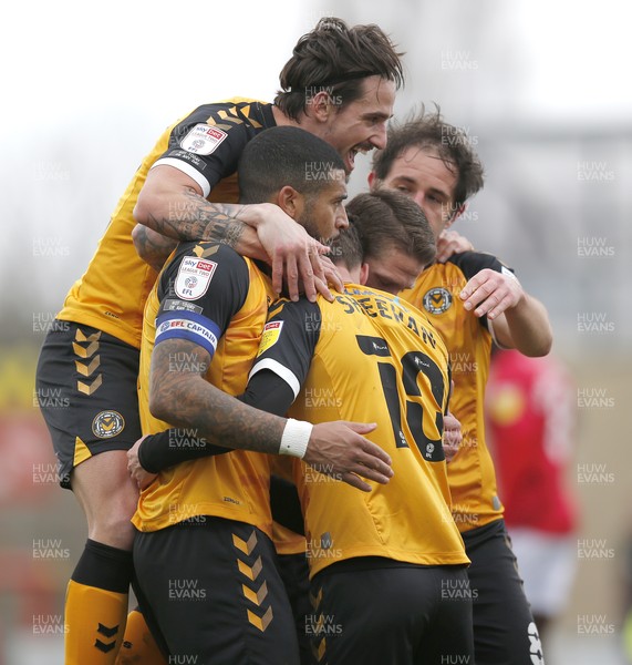 130321 - Morecambe v Newport County - Sky Bet League 2 - Josh Sheehan of Newport County celebrates scoring his team's 2nd goal with Ryan Taylor of Newport County and Mickey Demetriou of Newport County with Liam Shephard of Newport County on top