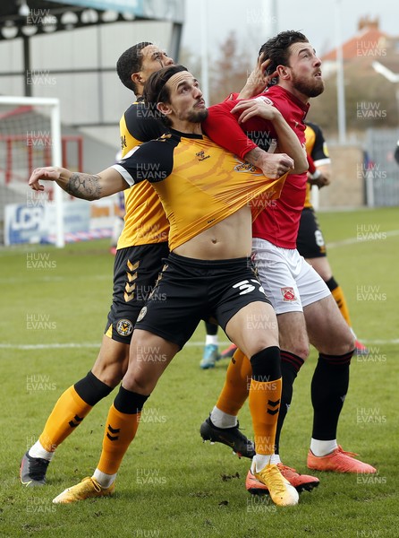 130321 - Morecambe v Newport County - Sky Bet League 2 - Liam Shephard of Newport County and Priestley Farquharson of Newport County and Cole Stockton of Morecambe FC await the oncoming ball