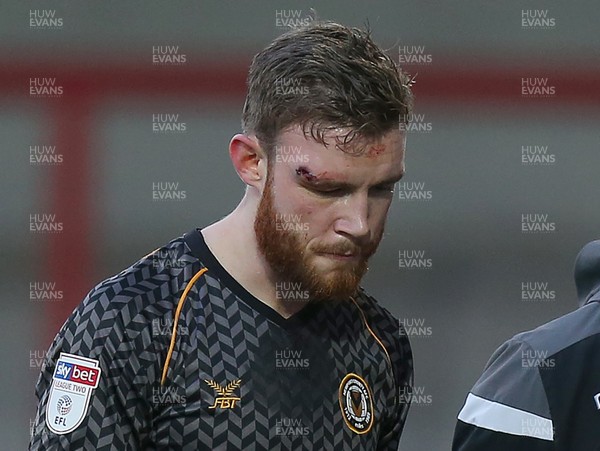 211219 - Morecambe v Newport County - Sky Bet League 2 -  Mark O'Brien of Newport County is taken off the pitch in the 1st half with a bad cut on the head
