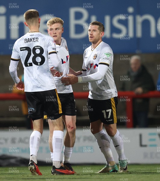 281123 - Morecambe v Newport County - Sky Bet League 2 - Goalscorer Will Evans of Newport County is surrounded after scoring the equaliser 1-1 by Matthew Baker and Scot Bennett of Newport County