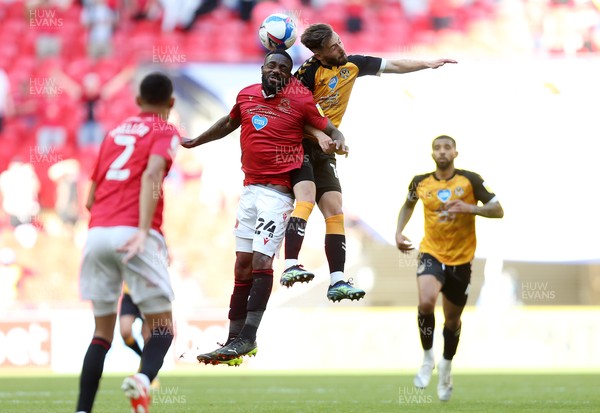 310521 - Morecambe v Newport County, SkyBet League 2 Play Off Final - Yann Songo'o of Morecambe and Josh Sheehan of Newport County go up for the ball