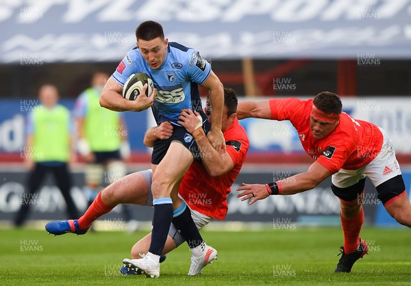 280521 - Munster v Cardiff Blues - Guinness PRO14 Rainbow Cup - Josh Adams of Cardiff Blues is tackled by Niall Scannell and CJ Stander of Munster