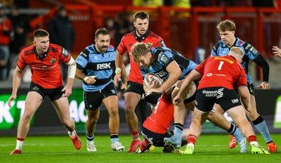 041025 - Munster v Cardiff Rugby, United Rugby Championship - Josh McNally of Cardiff Rugby is tackled by Munster players Jean Kleyn, left, and Jeremy Loughman