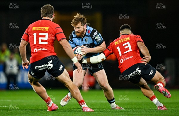 041025 - Munster v Cardiff Rugby, United Rugby Championship - Rory Jennings of Cardiff Rugby is tackled by Munster players Alex Nankivell, left, and Dan Kelly