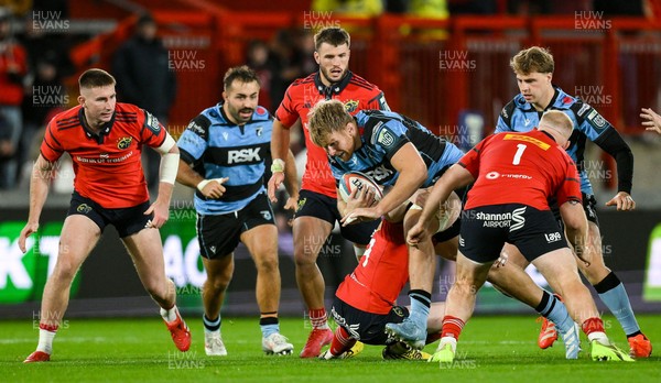 041025 - Munster v Cardiff Rugby, United Rugby Championship - Josh McNally of Cardiff Rugby is tackled by Munster players Jean Kleyn, left, and Jeremy Loughman