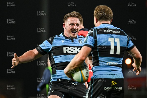 041025 - Munster v Cardiff Rugby, United Rugby Championship - Tom Bowen of Cardiff Rugby, right, is congratulated by team-mate Daf Hughes after scoring his side's third try