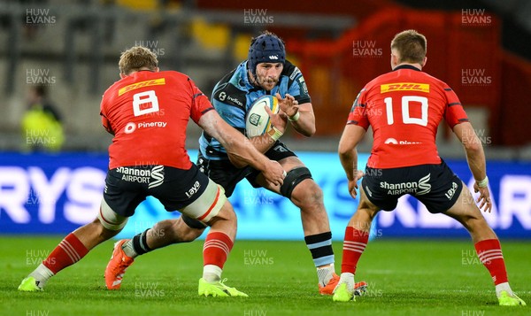041025 - Munster v Cardiff Rugby, United Rugby Championship - Alun Lawrence of Cardiff Rugby is tackled by Munster players Gavin Coombes, left, and Jack Crowley