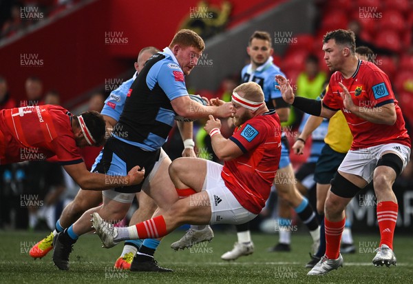 290422 - Munster v Cardiff Rugby - United Rugby Championship - Rhys Carre of Cardiff Blues in action against, Munster players, from left, Jean Kleyn, Jeremy Loughman and Peter O'Mahony