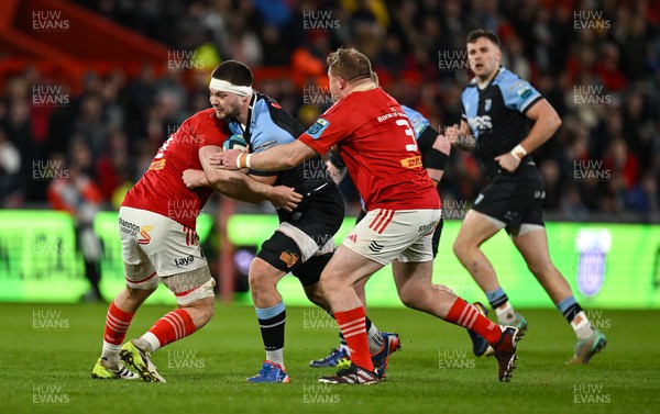300324 - Munster v Cardiff Rugby - United Rugby Championship - Ben Donnell of Cardiff is tackled by Gavin Coombes and Stephen Archer of Munster