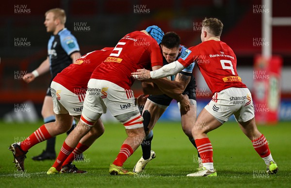 300324 - Munster v Cardiff Rugby - United Rugby Championship - Josh Adams of Cardiff is tackled by Tadhg Beirne and Craig Casey of Munster