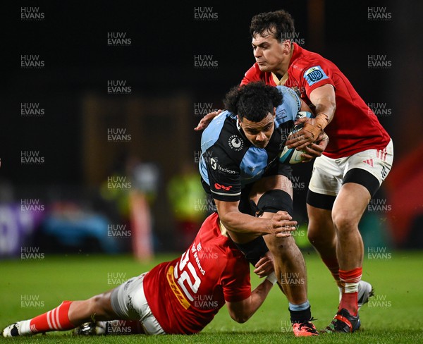 300324 - Munster v Cardiff Rugby - United Rugby Championship - Mackenzie Martin of Cardiff is tackled by Antoine Frisch and Joey Carbery of Munster
