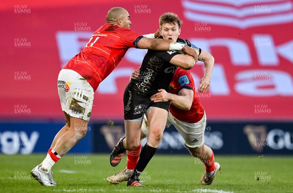 050322 - Munster v Dragons - United Rugby Championship - Will Talbot-Davies of Dragons is tackled by Simon Zebo and Jack O�Donoghue of Munster