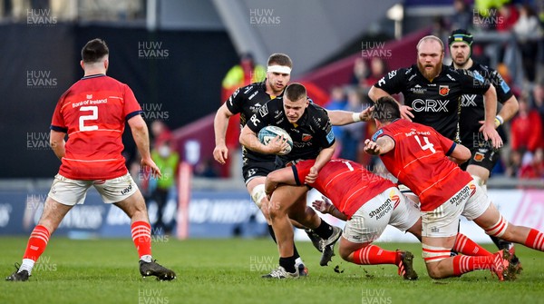 050322 - Munster v Dragons - United Rugby Championship - Taylor Davies of Dragons is tackled by Chris Cloete of Munster