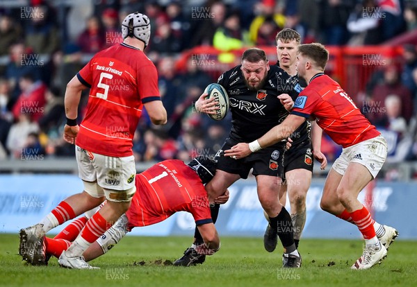 050322 - Munster v Dragons - United Rugby Championship - Greg Bateman of Dragons is tackled by Josh Wycherley and Jack Crowley of Munster