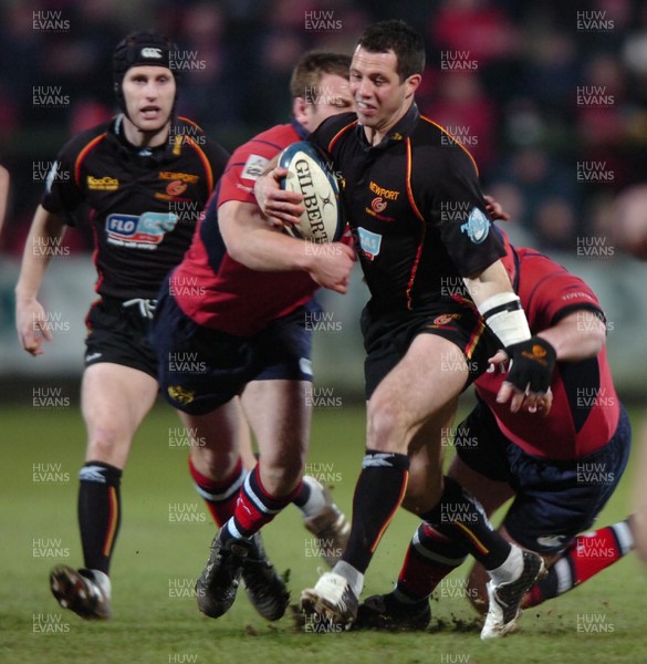 280106  Munster v Gwent Dragons  Gareth Cooperis tackled by Anthony Foley   