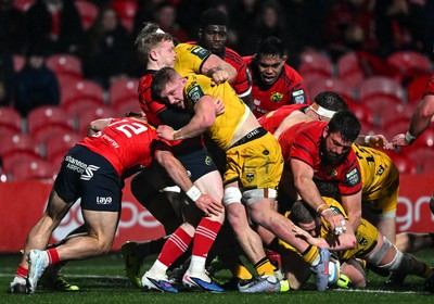 230126 - Munster v Dragons RFC - United Rugby Championship - Brodie Coghlan of Dragons, hidden, dives over to score his side's first try
