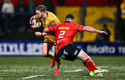 230126 - Munster v Dragons RFC - United Rugby Championship - Angus O'Brien of Dragons is tackled by Diarmuid Barron of Munster