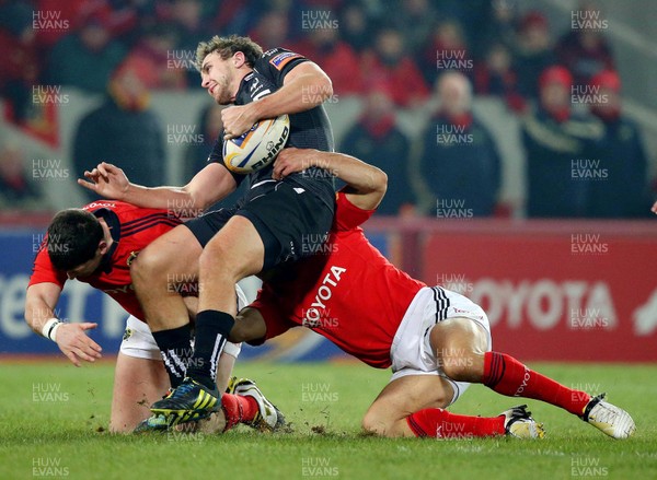 020313 Munster v Ospreys - RaboDirect Pro 12 - Munster's Doug Howlett and Felix Jones tackle Ashley Beck of Ospreys 