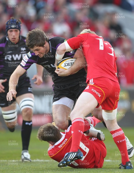 14.05.11 - Musnter v Ospreys...  Ospreys Andrew Bishop is tackled by Munster's Ronan O'Gara and  Danny Barnes. 