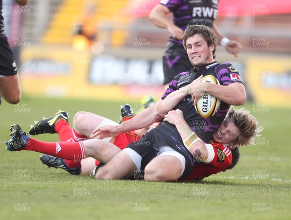 14.05.11 - Musnter v Ospreys... Ospreys Andrew Bishop is tackled by Munster's Danny Barnes and Munster's Marcus Horan. 